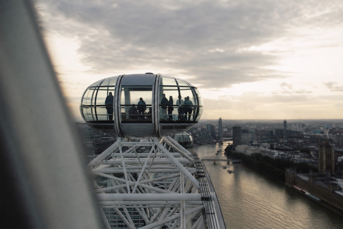 A London Eye capsule against a navy evening sky over the Thames